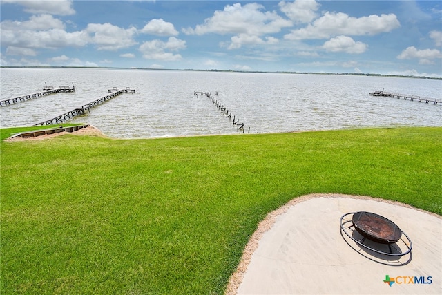 view of water feature with a boat dock and a fire pit