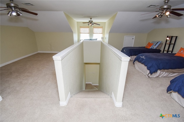 interior space featuring carpet flooring, vaulted ceiling, and ceiling fan