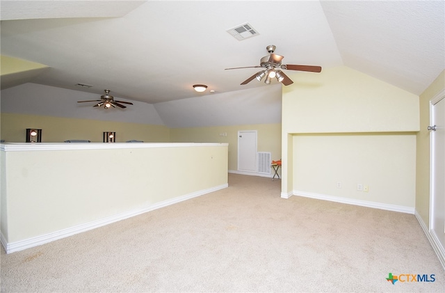 additional living space featuring ceiling fan, light colored carpet, and lofted ceiling