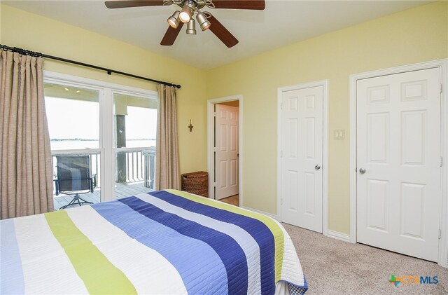 carpeted bedroom with ceiling fan and access to exterior