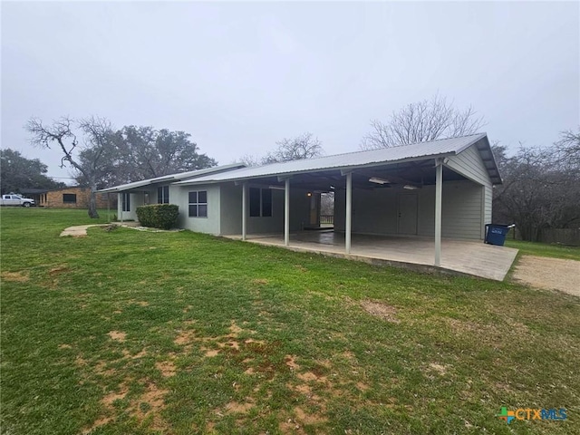 back of property with a yard and a patio area