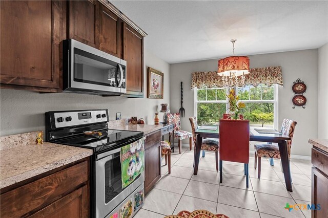 182 Palm, Spring Branch, TX 78070 - kitchen with appliances with stainless steel finishes, a chandelier, light countertops, dark brown cabinetry, and hanging light fixtures