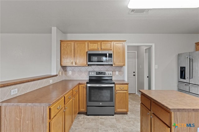 kitchen featuring decorative backsplash and stainless steel appliances