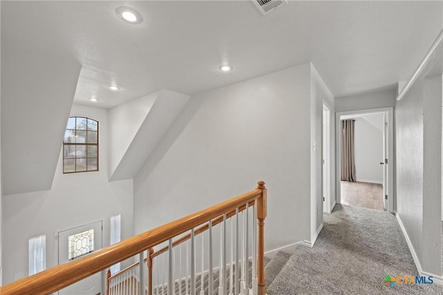 hallway with light colored carpet