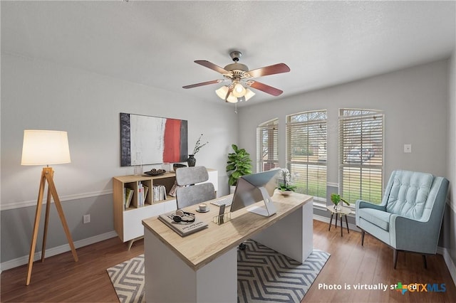 home office with hardwood / wood-style flooring and ceiling fan