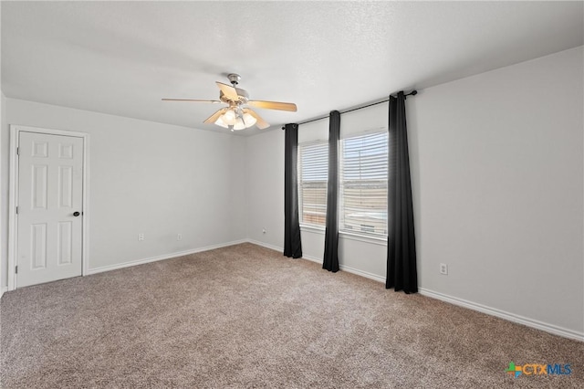 unfurnished room featuring light carpet and ceiling fan