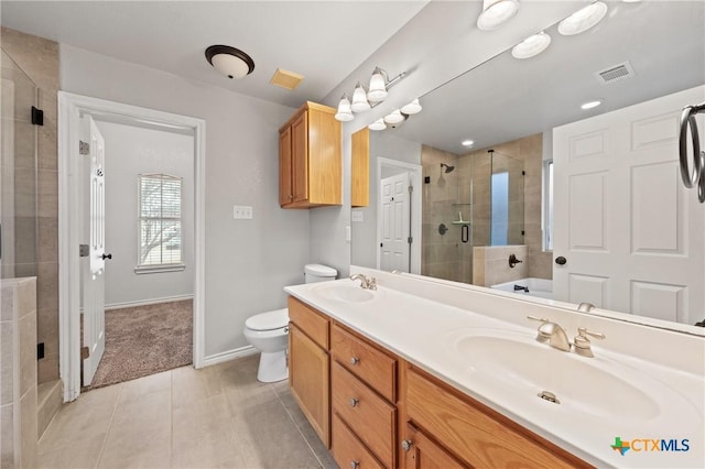 bathroom with vanity, toilet, a shower with shower door, and tile patterned flooring