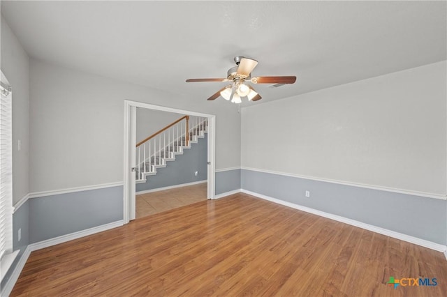 unfurnished room featuring ceiling fan and light wood-type flooring