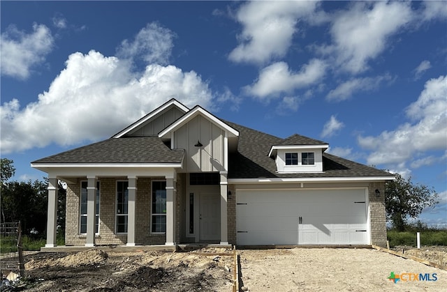 view of front of home with a garage and a porch