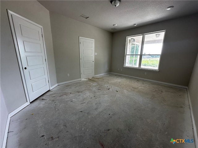 empty room with a textured ceiling