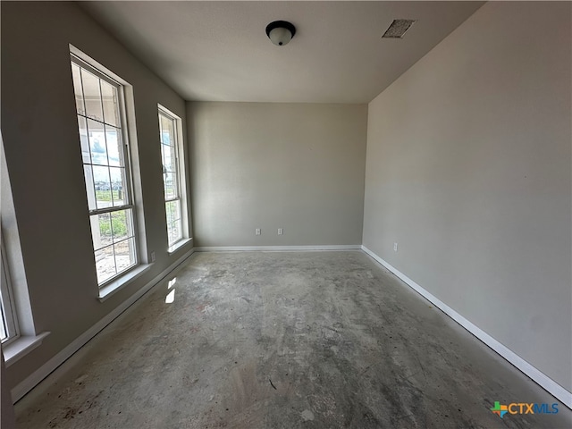 unfurnished room featuring concrete flooring