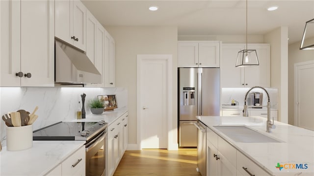 kitchen with white cabinets, sink, pendant lighting, light wood-type flooring, and appliances with stainless steel finishes