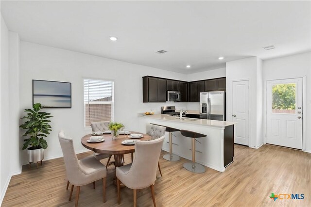 383 Soapstone Pass, San Marcos, TX 78656 - dining area with light wood finished floors, recessed lighting, and baseboards