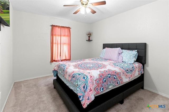 bedroom featuring light colored carpet and ceiling fan