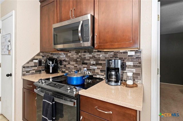 kitchen with backsplash and stainless steel appliances