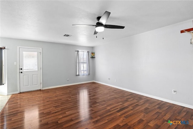 empty room featuring dark wood-type flooring and ceiling fan