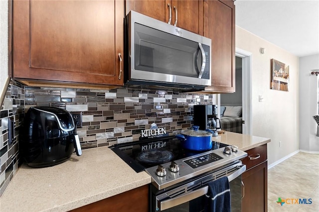 kitchen with stainless steel appliances and decorative backsplash