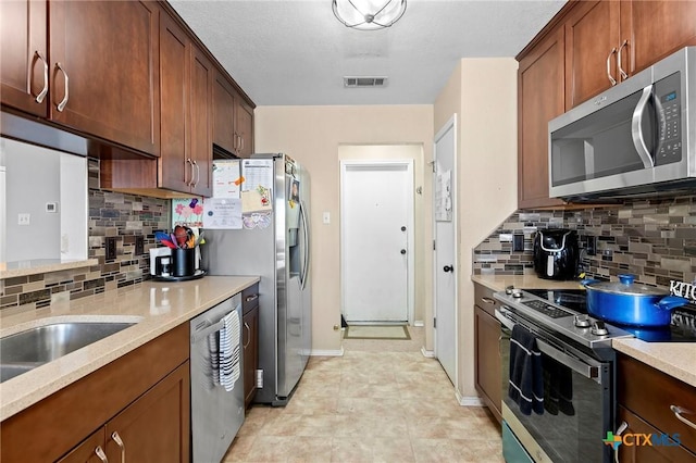 kitchen with stainless steel appliances and tasteful backsplash