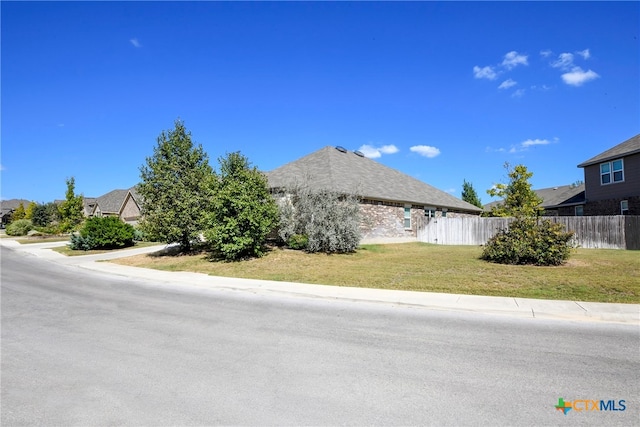 view of side of home with a lawn