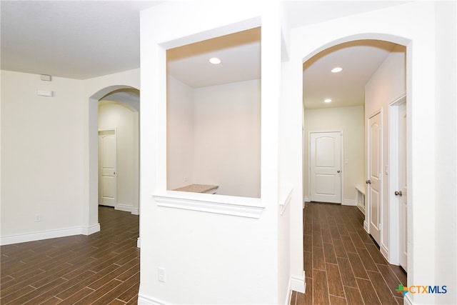 hallway with dark wood-type flooring