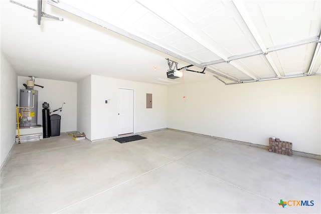 garage featuring electric panel, a garage door opener, and water heater