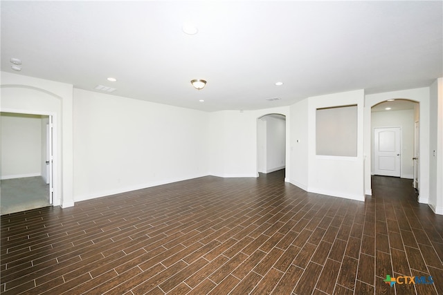 unfurnished room with dark hardwood / wood-style floors