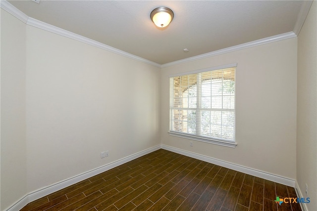 empty room featuring ornamental molding and dark hardwood / wood-style flooring