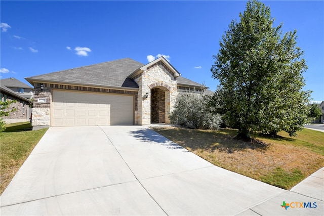 view of front facade with a garage and a front lawn