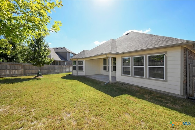 back of property featuring a patio and a yard