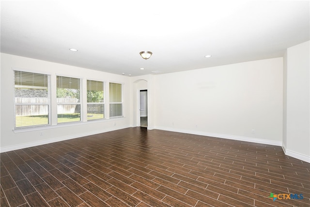 unfurnished room with dark hardwood / wood-style flooring