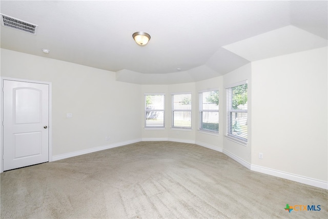 spare room featuring light colored carpet