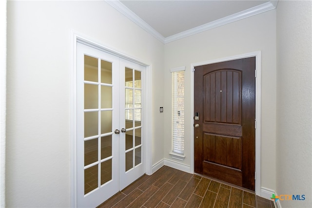 entrance foyer with ornamental molding, french doors, and dark wood-type flooring