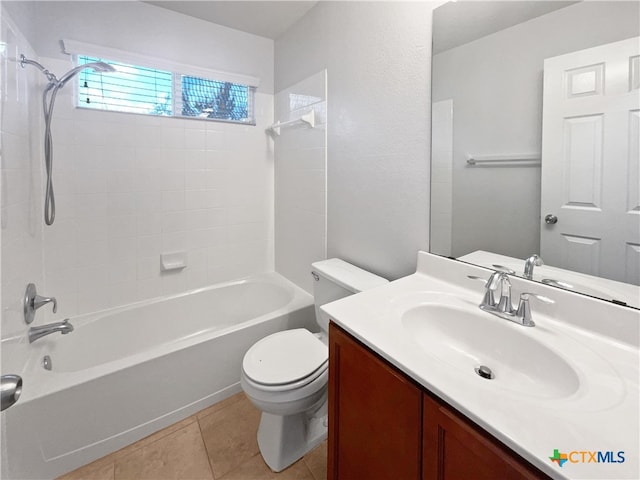 full bathroom featuring toilet, vanity, tiled shower / bath, and tile patterned floors