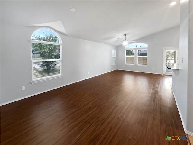 unfurnished living room featuring dark wood-type flooring, ceiling fan, and vaulted ceiling