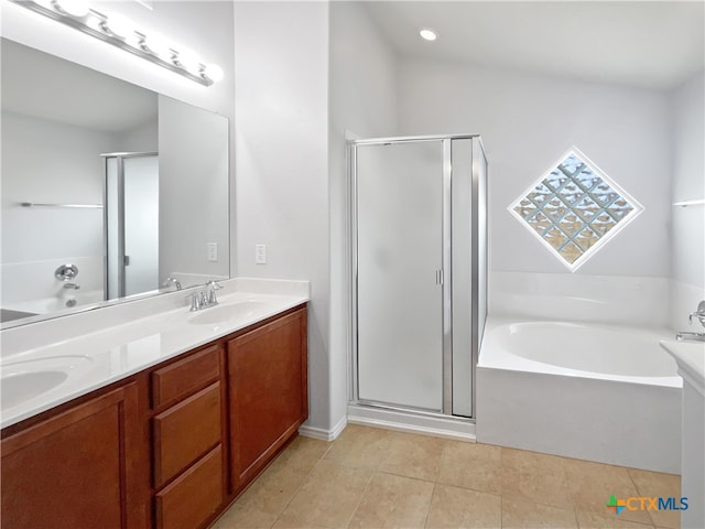 bathroom with tile patterned flooring, vanity, and plus walk in shower