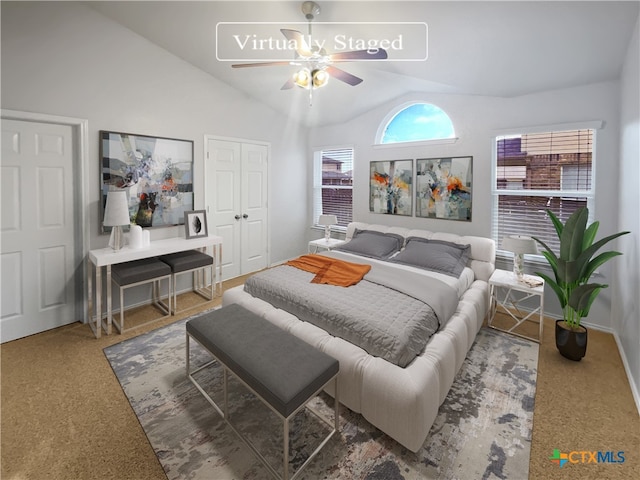 carpeted bedroom featuring ceiling fan and vaulted ceiling