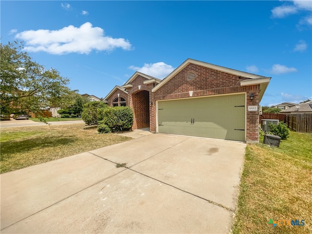 view of front of home with a front lawn and a garage