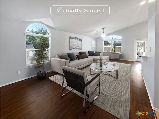 living room featuring dark hardwood / wood-style flooring, vaulted ceiling, and ceiling fan