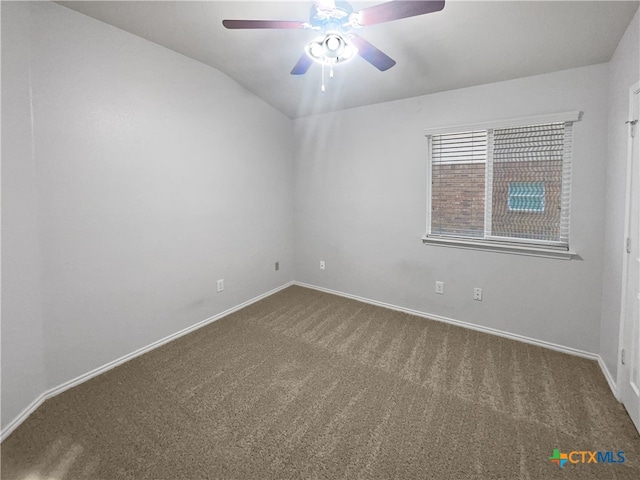 carpeted empty room featuring ceiling fan and vaulted ceiling