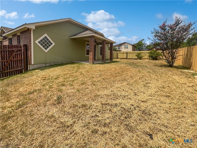 rear view of house with a yard