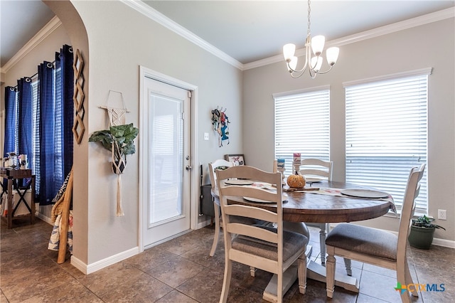 tiled dining space featuring a wealth of natural light, an inviting chandelier, and crown molding