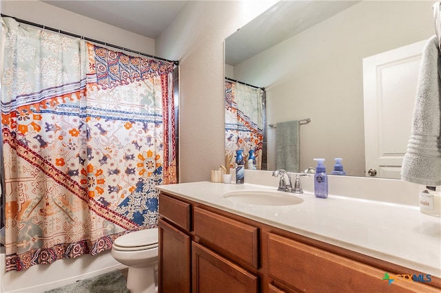 bathroom with toilet, vanity, and curtained shower