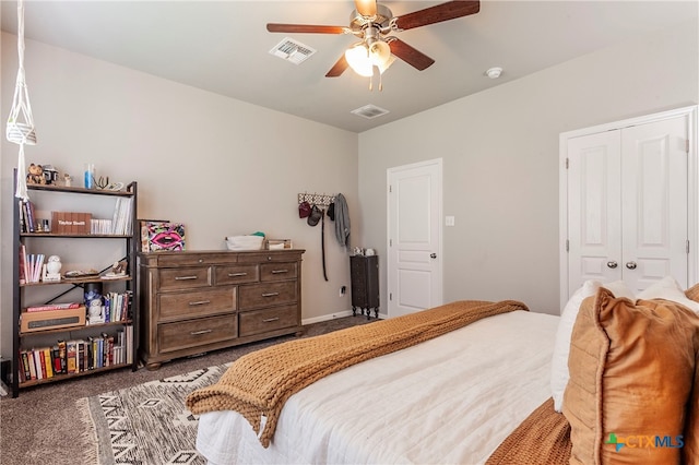 carpeted bedroom with ceiling fan and a closet