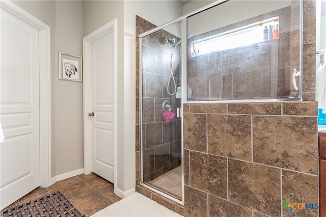 bathroom with tile patterned floors and a shower with door