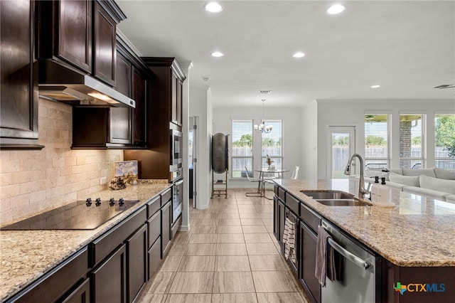 kitchen featuring black electric cooktop, dishwasher, decorative backsplash, hanging light fixtures, and sink