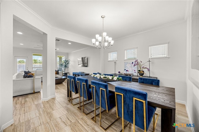 dining room with ornamental molding and a chandelier