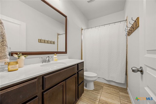 bathroom featuring vanity, tile patterned floors, and toilet