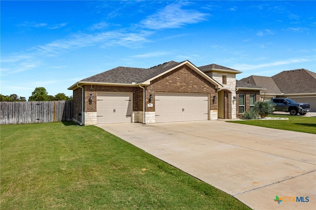 view of front of home featuring a garage and a front lawn