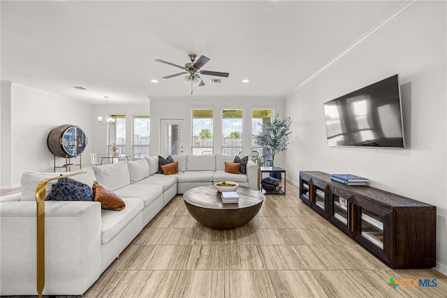 living room featuring ceiling fan with notable chandelier and crown molding