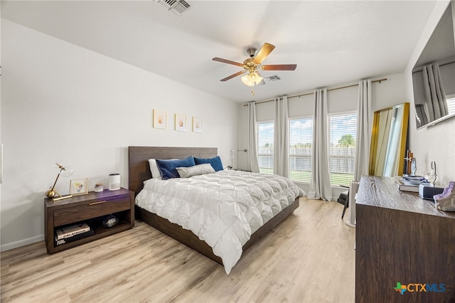 bedroom with light hardwood / wood-style floors and ceiling fan